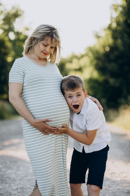 Pregnant youg woman with her son