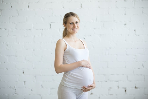 Pregnant young woman portrait indoors