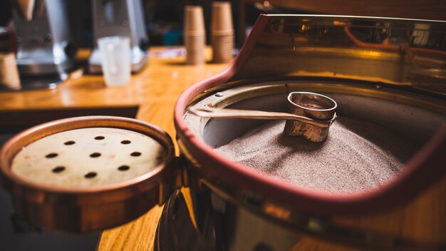 Preparation of coffee in cezve on hot sand at coffee bar