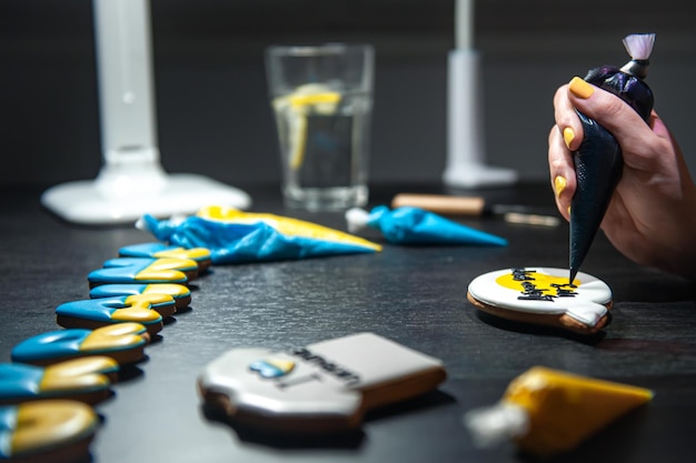 Preparation of handmade gingerbread with symbols of ukraine icing