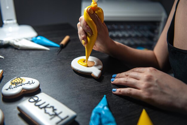 Preparation of handmade gingerbread with symbols of ukraine icing