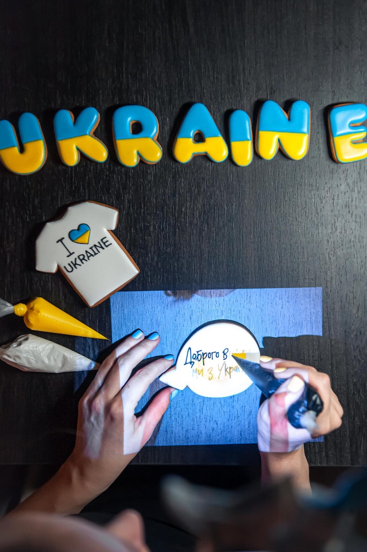 Free Photo preparation of handmade gingerbread with symbols of ukraine icing