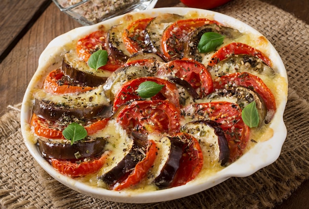 Prepared gratin dish raw eggplant with mozzarella and tomatoes