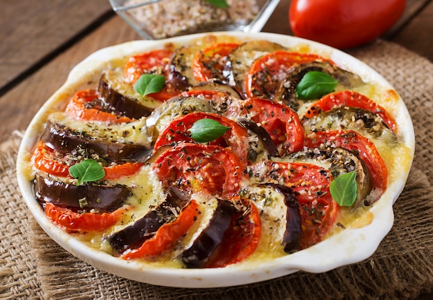 Prepared gratin dish raw eggplant with mozzarella and tomatoes