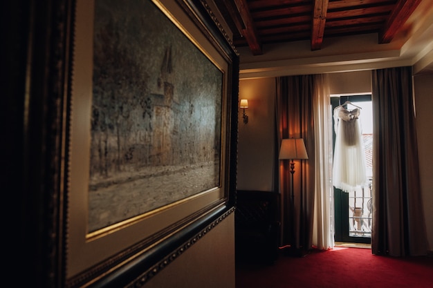 Prepared wedding dress in an empty room of the hotel