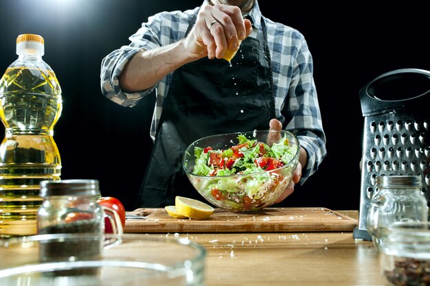 Preparing salad. Female chef cutting fresh vegetables. Cooking process. Selective focus