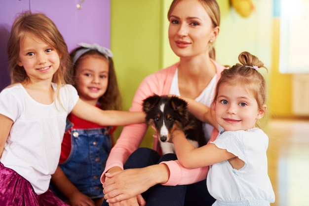 Preschool children having fun with dog