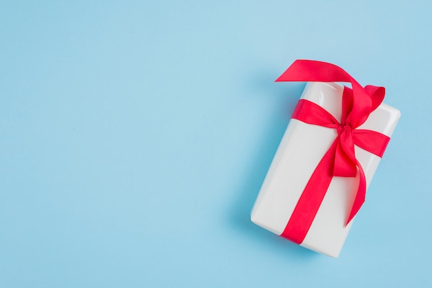 Present box with red ribbon