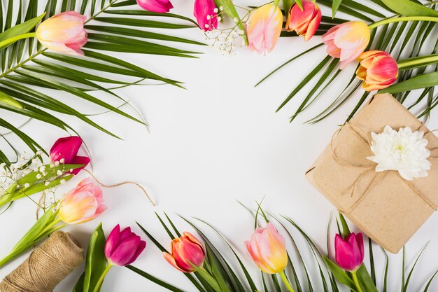 Present box with tulips and palm