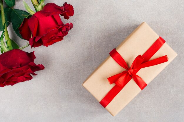 Present box in wrap and flowers 