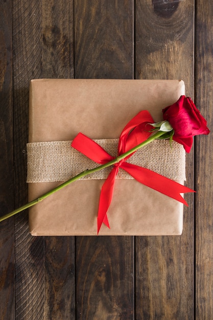 Present box in wrap and fresh bloom