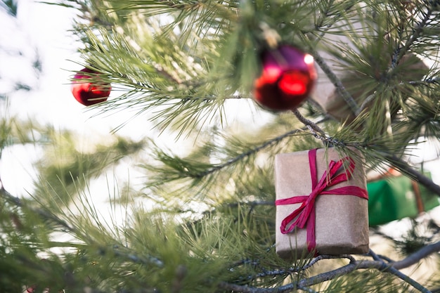 Present boxes and christmas balls in tree