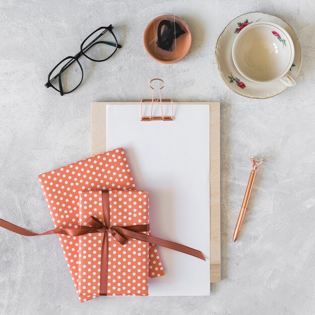 Present boxes, eyeglasses, clipboard and cup