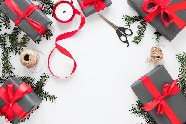 Present boxes near fir twigs and ribbon 