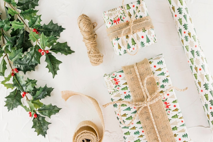 Free Photo present boxes near green twig and clew of threads 