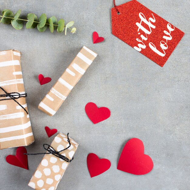 Present boxes near paper hearts and tag 