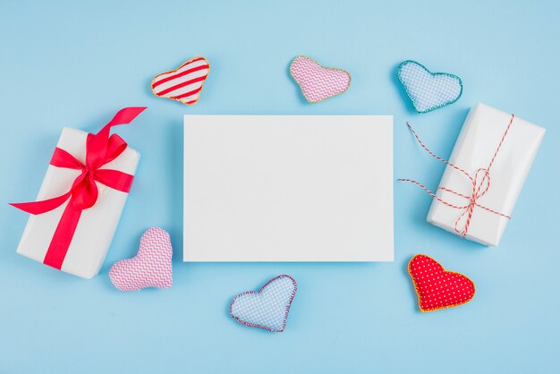 Present boxes near paper and toy hearts