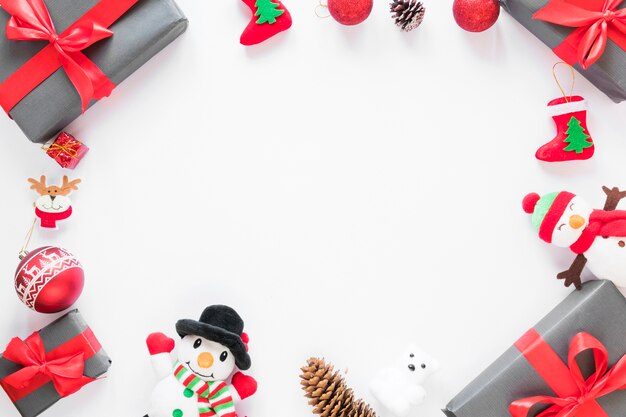 Present boxes near toy snowmen and Christmas ball 