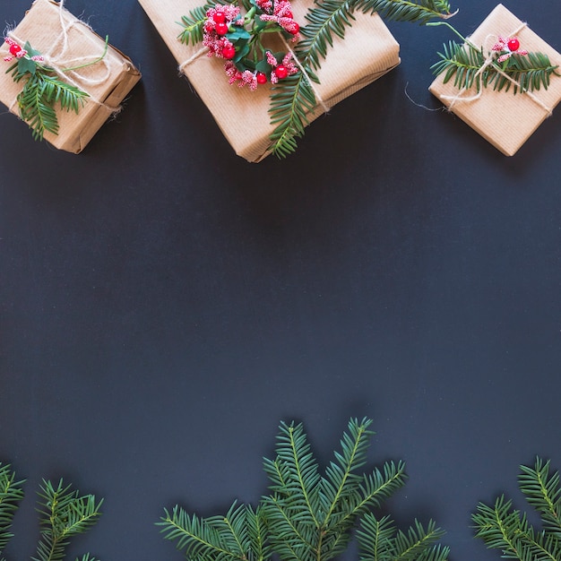 Present boxes with flowers and fir branches 