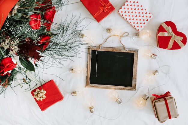 Presents and light garland around chalkboard