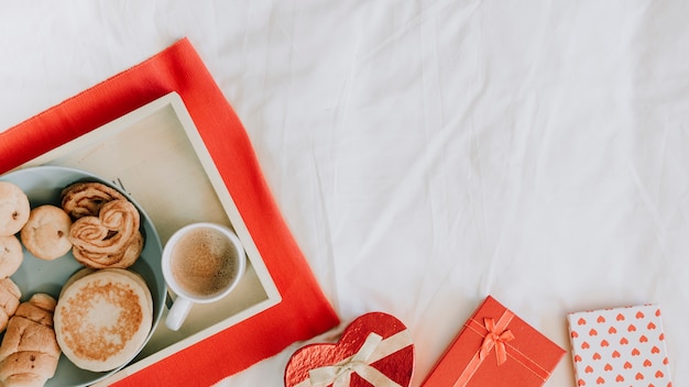 Presents near tray with breakfast