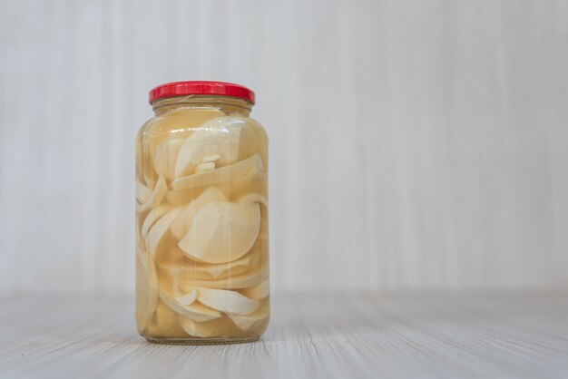 Preserve of guariroba inside the pot on the white wooden background