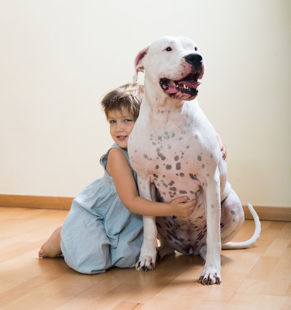 Ragazza preteen sul pavimento con il cane