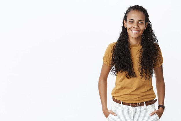 Pretty african american female student looking at camera with pleased smile