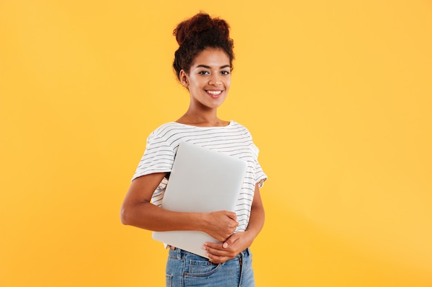 Pretty african lady holding laptop