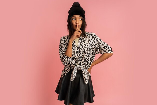 Pretty african woman in black hat and stylish blouse posing  