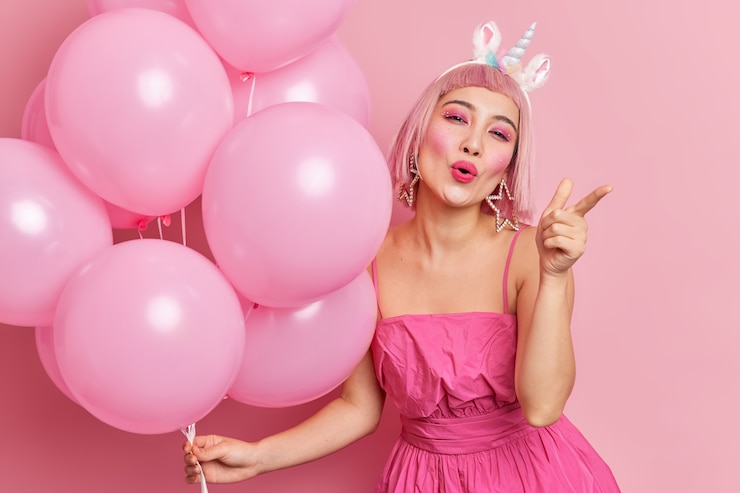 Free Photo pretty asian woman points directly at camera has bright makeup invites you for party