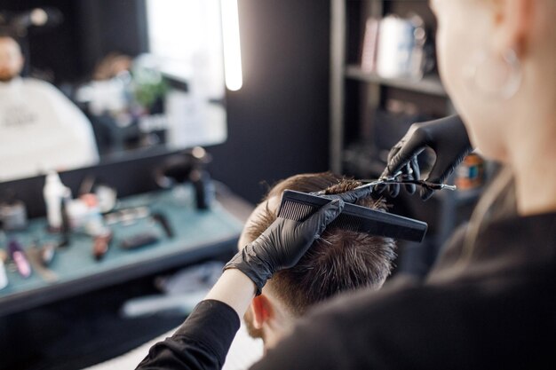 pretty barber girl cutting hair