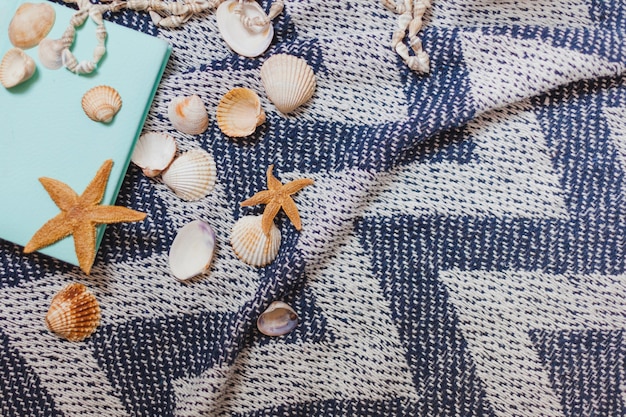 Pretty beach towel with book and starfish