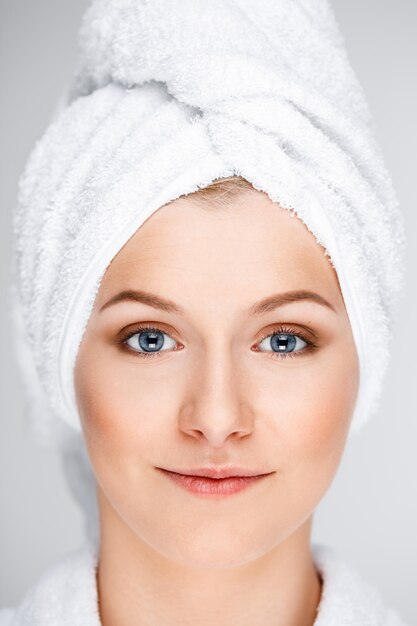 Pretty blond woman wrap bath towel over wet hair