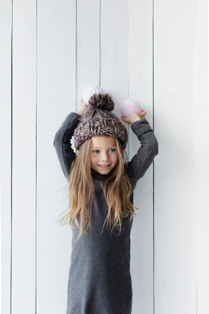 Pretty blonde girl holding snowballs