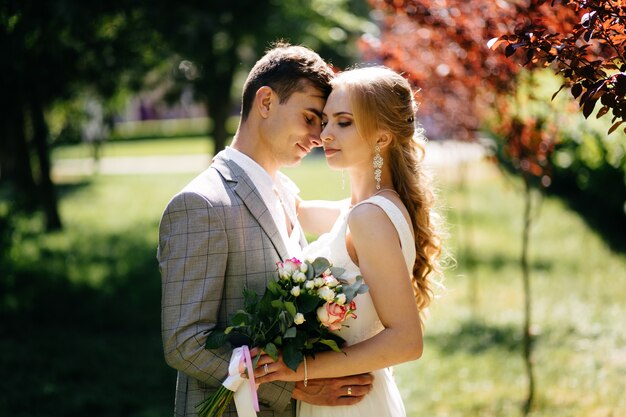 Pretty blonde girl with long hair and handsome guy in park.