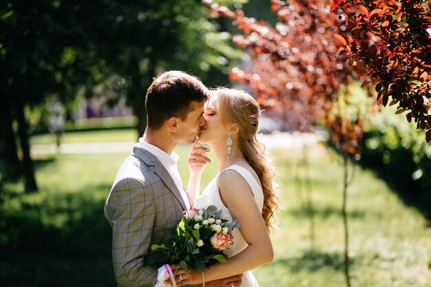 Pretty blonde girl with long hair and handsome guy in park.