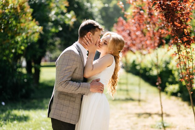 Pretty blonde girl with long hair and handsome guy in park.