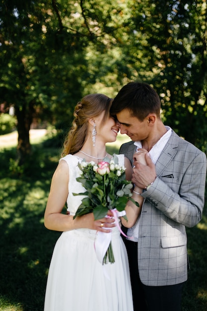 Pretty blonde girl with long hair and handsome guy in park.