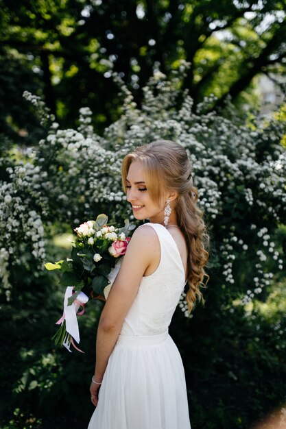 Pretty blonde girl with long hair in park.