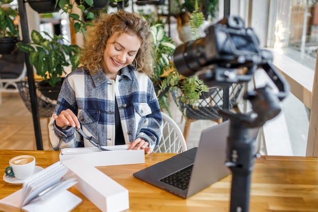 Free photo pretty blonde influencer testing new products on the camera