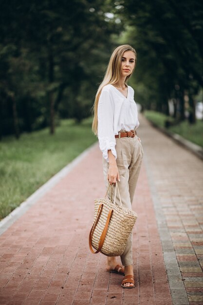 Pretty blonde woman in park wearing summer look