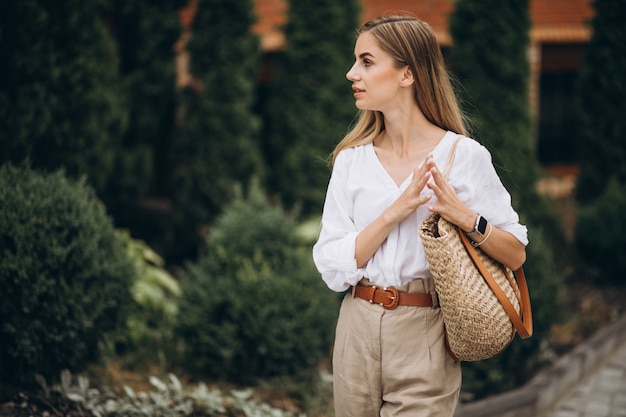 Pretty blonde woman in park wearing summer look