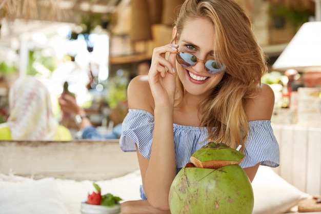 Pretty blonde woman sitting in cafe