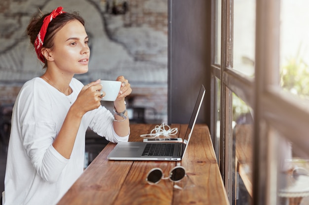 Pretty blonde woman sitting in cafe