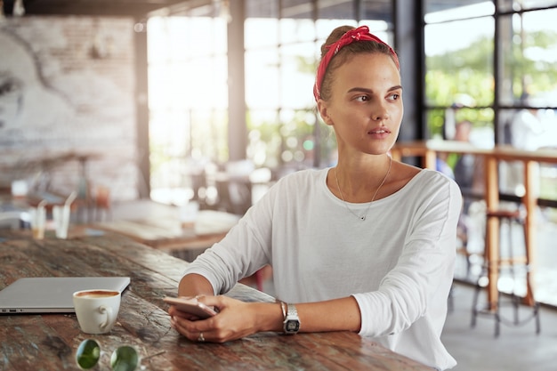 Pretty blonde woman sitting in cafe