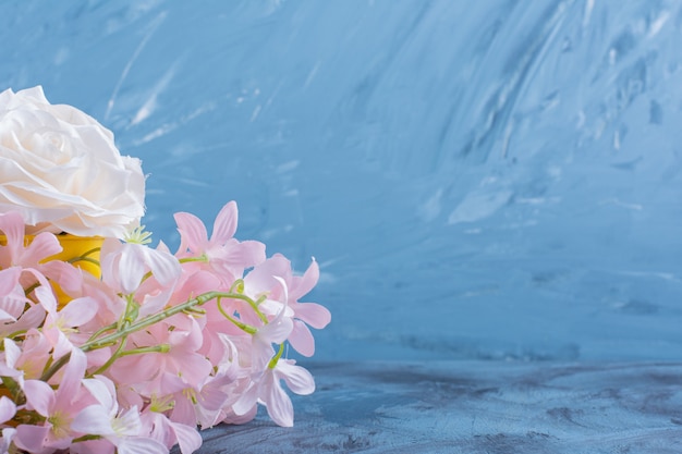 Pretty bouquet of white and pink flowers on blue.