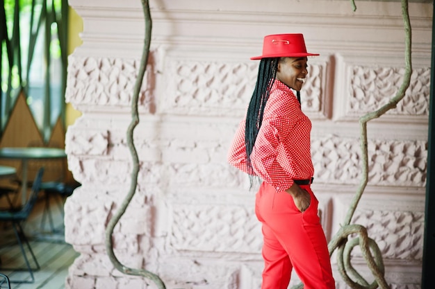 Pretty braids business african american lady bright bossy person friendly wear office red shirt hat and trousers