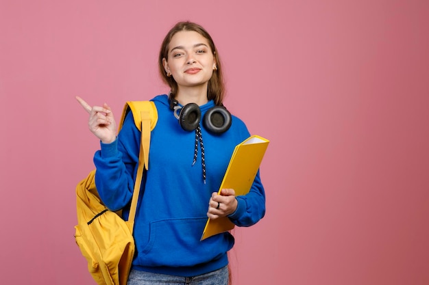 Pretty brunette female standing pointing by finger