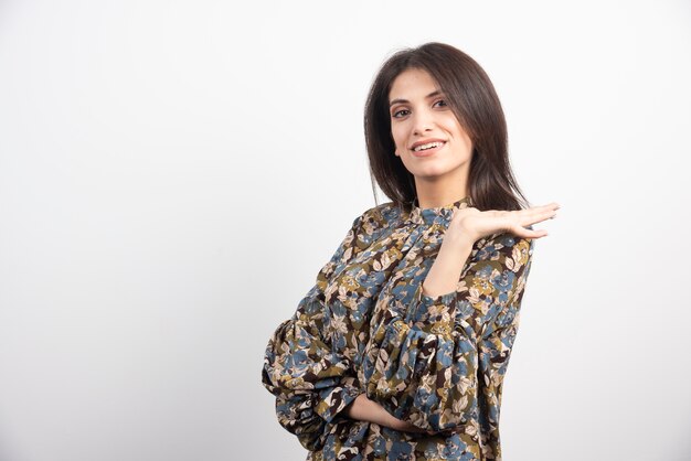 Pretty brunette woman posing on a white background. 